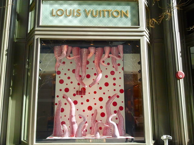 Louis Vuitton storefront exterior with Yayoi Kusama window displays
