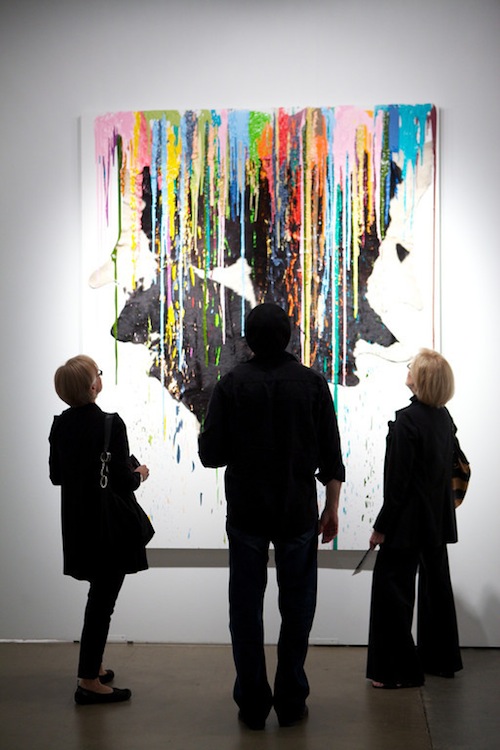 Three visitors look up at a work of art at Expo Chicago 2012