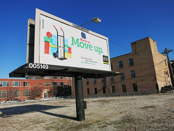 A billboard with Baird and Warner ad reading "Move in, Move Up," paired with vibrant illustrations