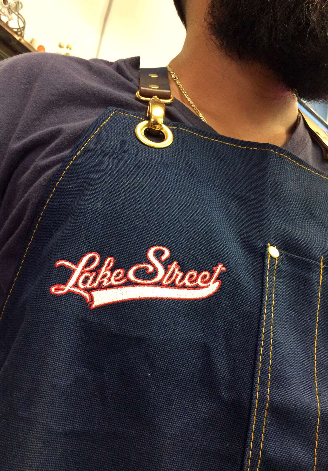 Logo design for Lake Street Barbers, executed on an apron
